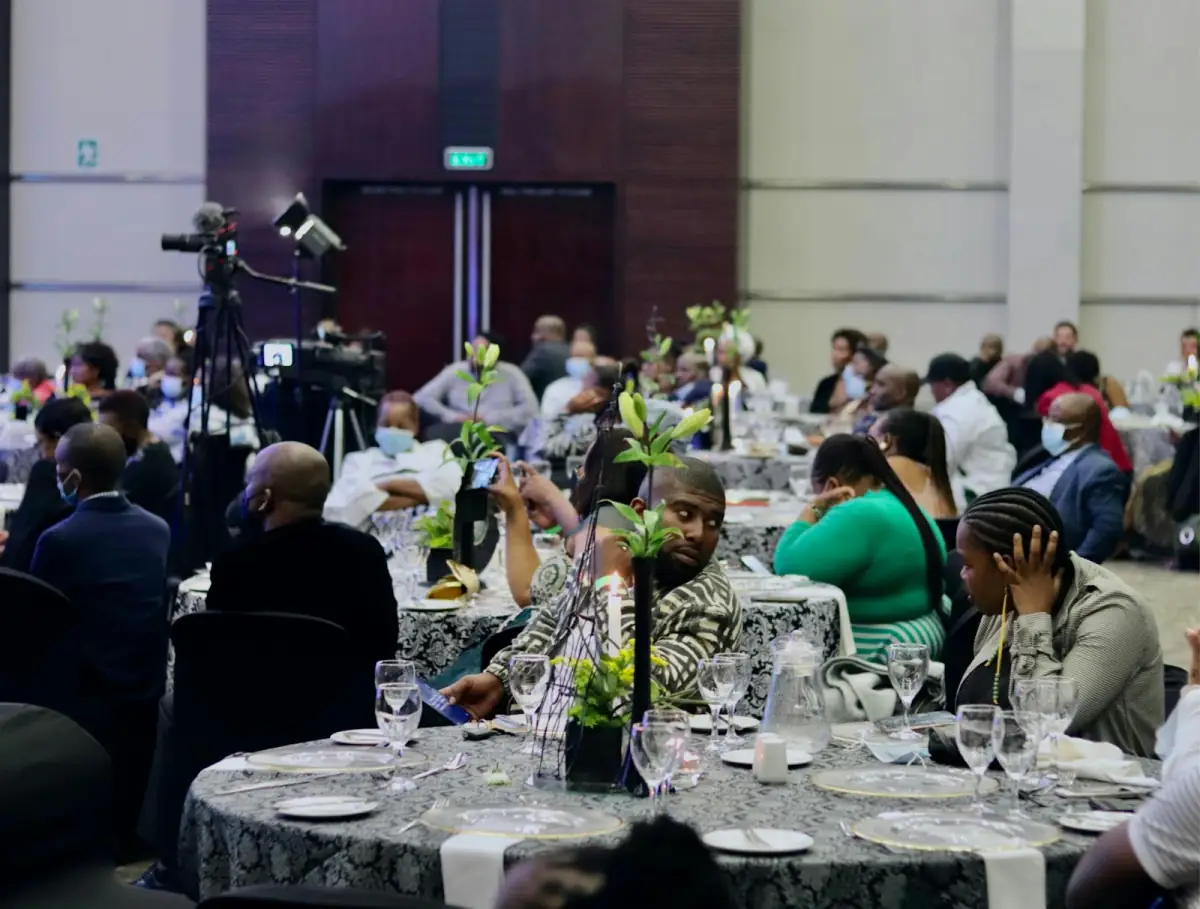 Delegates seated at round tables during a formal conference