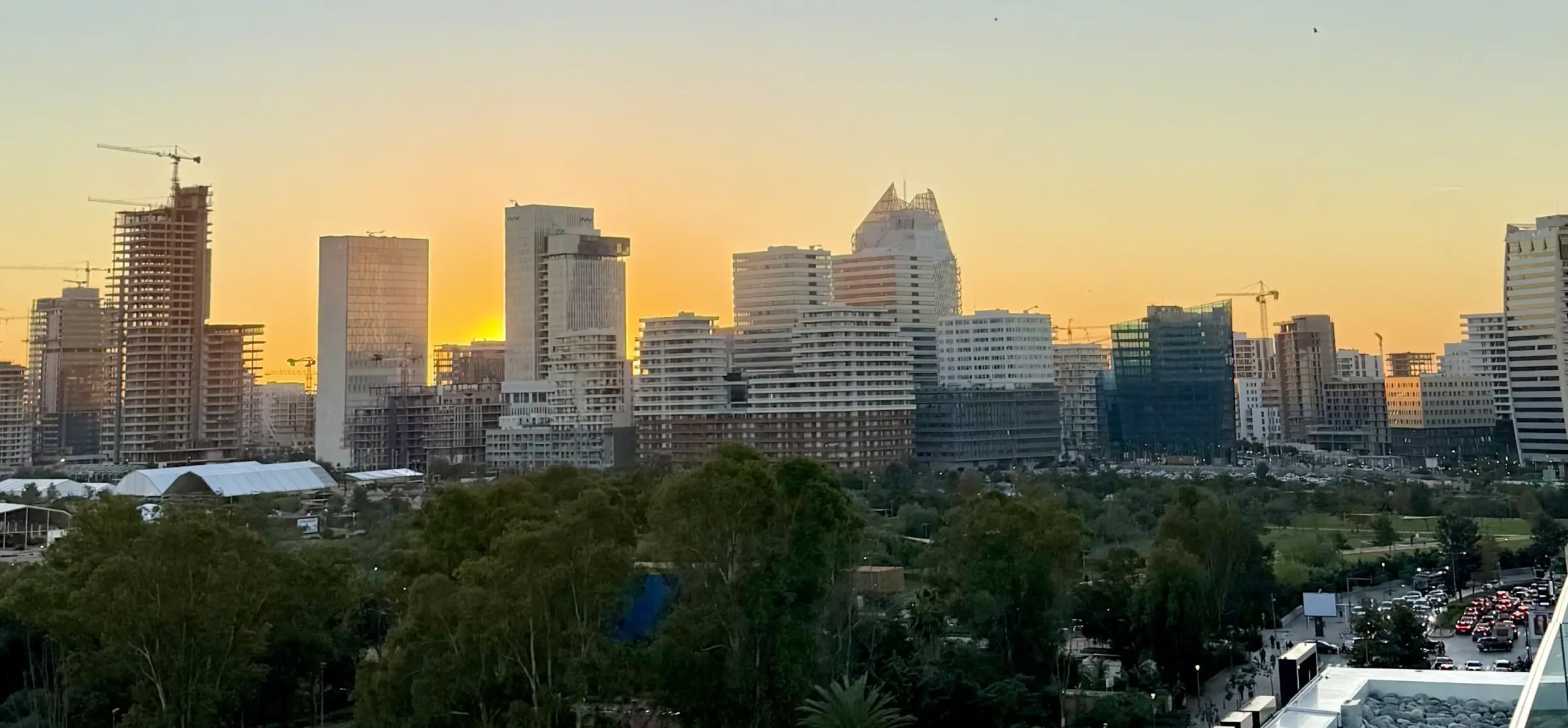 Casablanca Finance City at sunset: the CFC Tower and the Anfa business district rising above the park